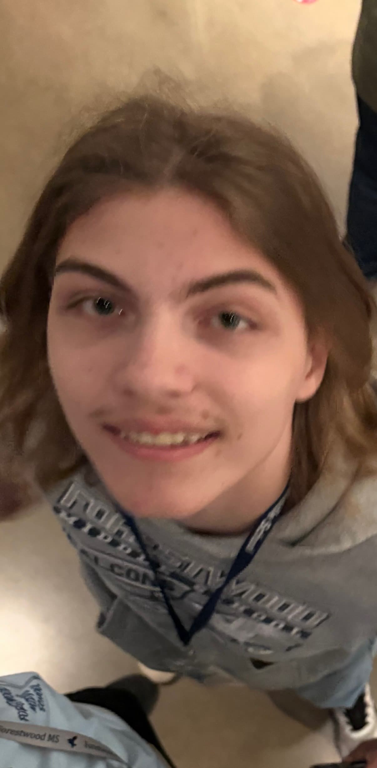 Carter smiling in a gray hoodie